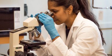 Lab worker at microscope